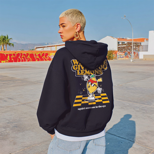 Person wearing a black hoodie with a colorful graphic design outdoors.