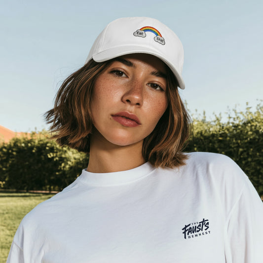Person wearing a white cap and t-shirt with visible branding outdoors