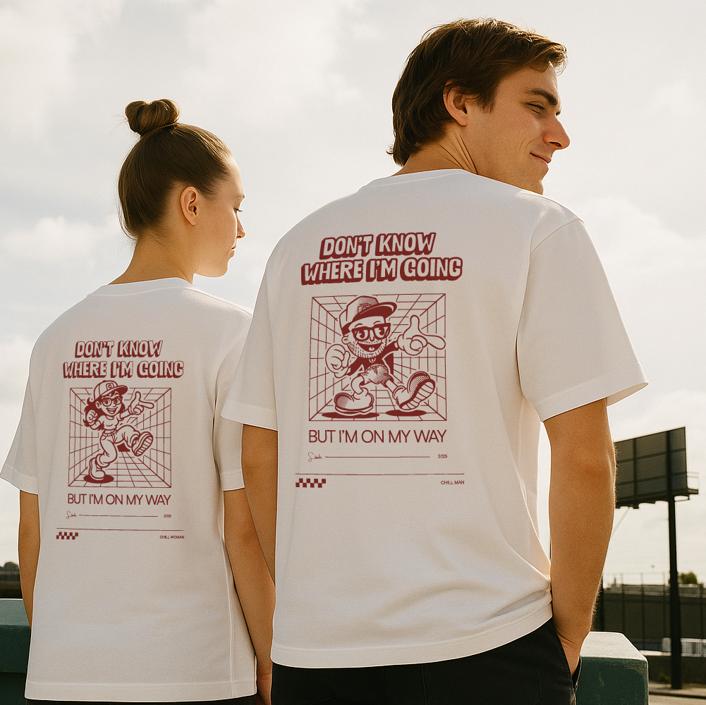 Two people wearing white t-shirts with red graphics and text outdoors.