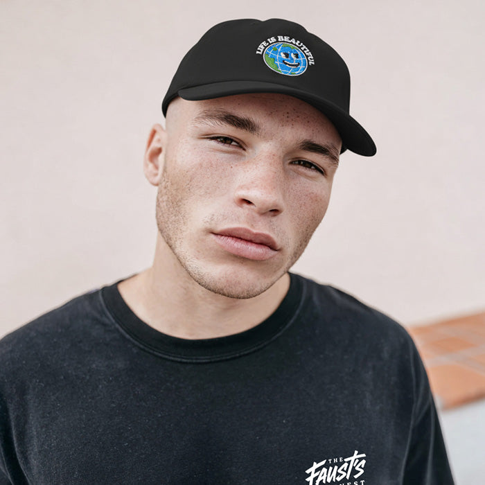 Man wearing a black cap and black sweatshirt with visible branding against a neutral background