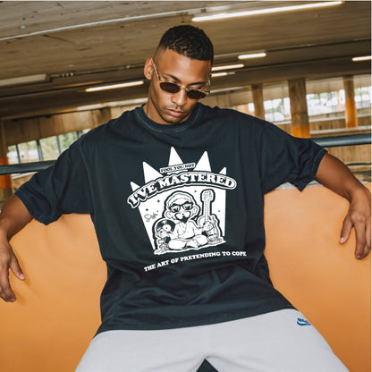 Man wearing a black t-shirt with a graphic design sitting on an orange bench.