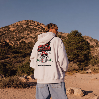 Person wearing a hoodie with a graphic design in a desert landscape