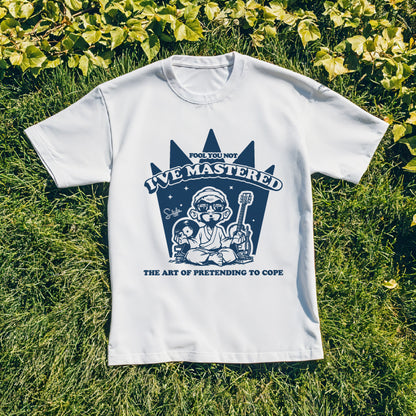 White t-shirt with blue graphic design on grass