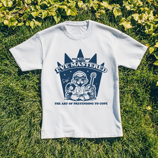 White t-shirt with blue graphic design on grass