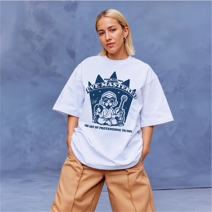 Person wearing a white t-shirt with a graphic design on a blue background