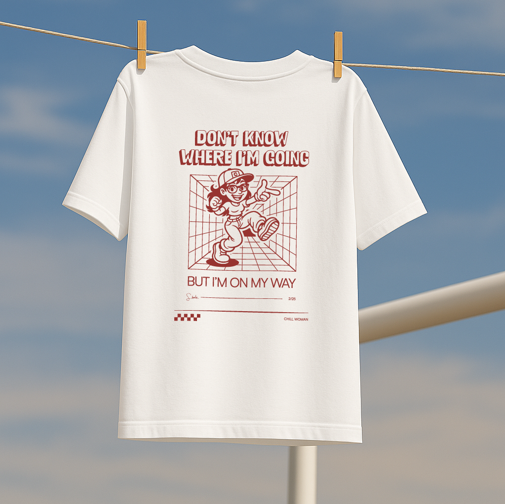 White t-shirt with red graphic and text on a clothesline against a blue sky.