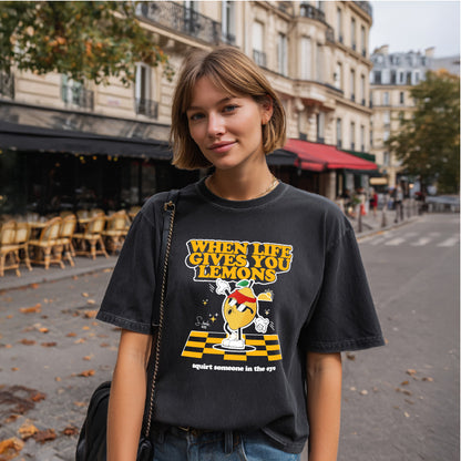 Person wearing a black t-shirt with a graphic design in an urban setting
